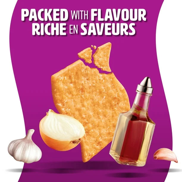 Promotional graphic for flavored chips with a bottle of sauce, onion, garlic, and text on a purple background.